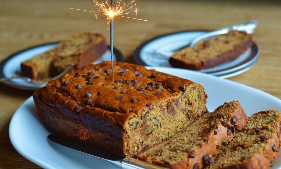 Baked banana bread over a board with a fire stick 