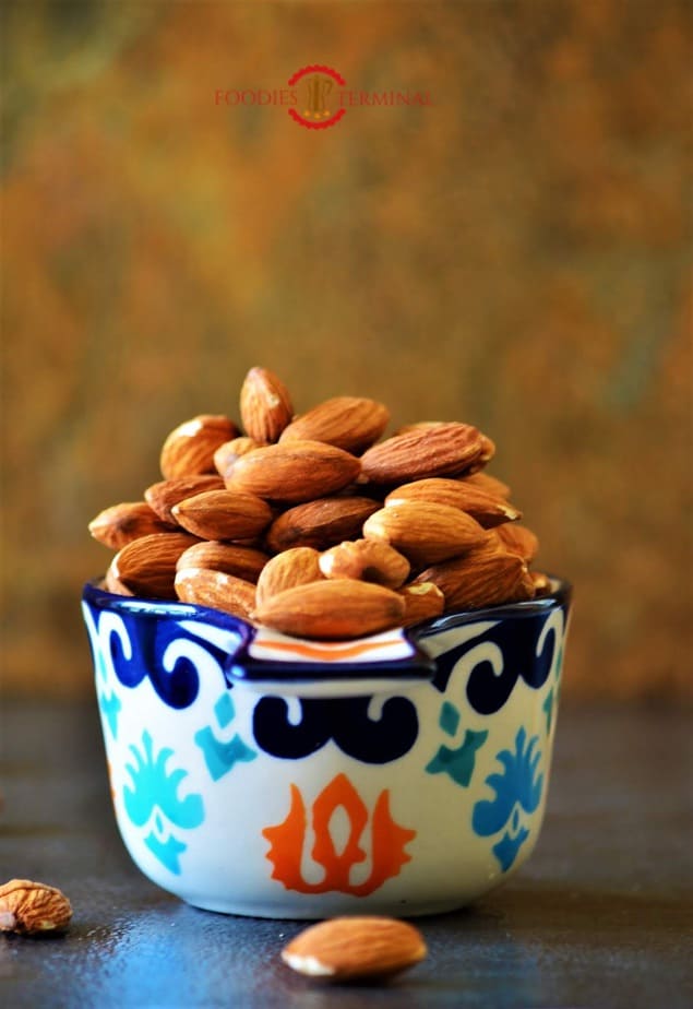 Almonds in a measuring cup.