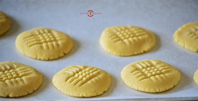 Shortbread cookies formed and ready to bake on a tray