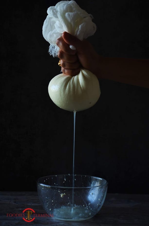 Squeezing cottage cheese in a cloth