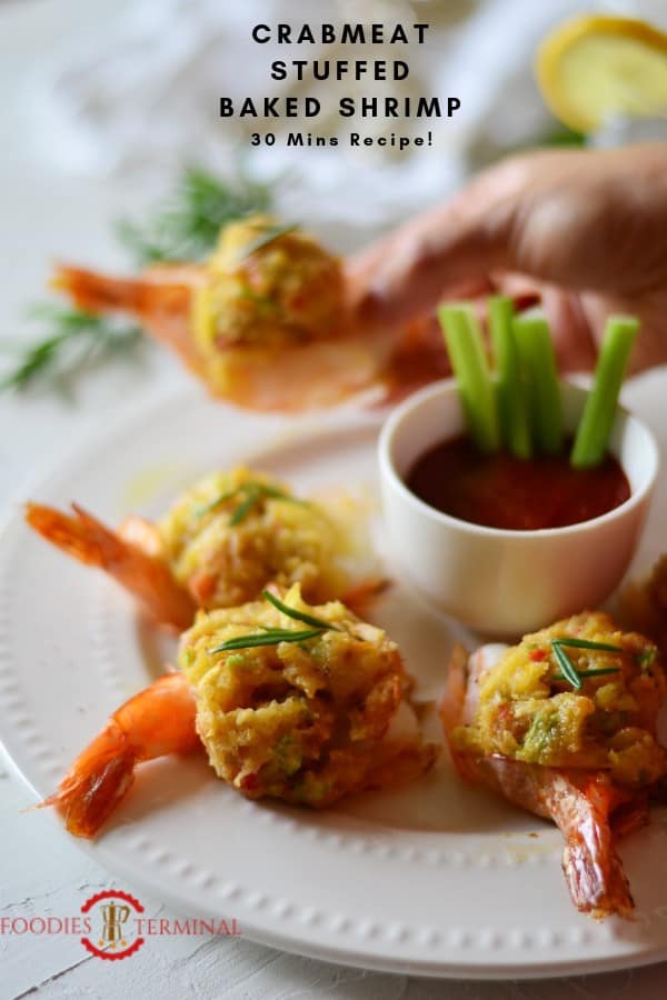 Easy Baked Stuffed Shrimp with Crabmeat & Ritz crackers served on a plate held with hands.