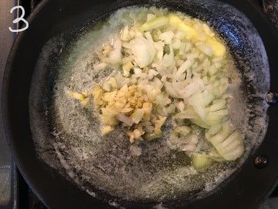 Chopped onion and garlic in pan to be sautéed.