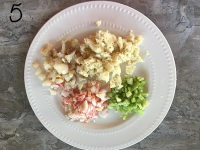 Crab meat, celery, fish and bread keep aside in a plate.