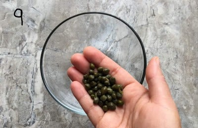 Adding capers to a bowl