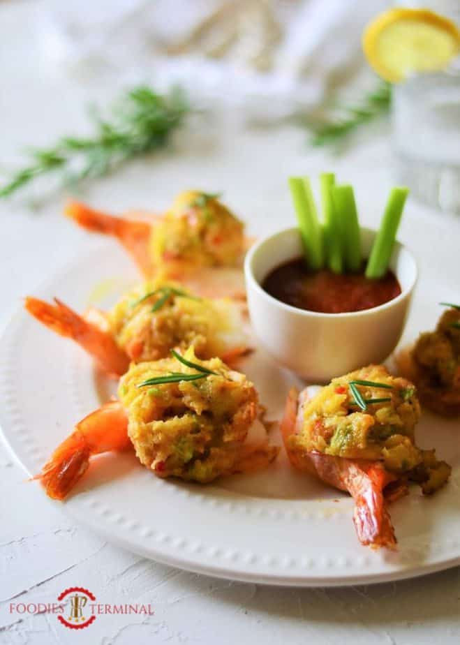 Easy Baked Stuffed Shrimp with Crabmeat & Ritz crackers served on a plate with sauce.