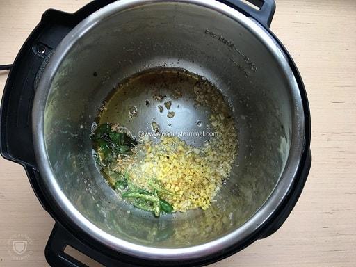 Frying chopped garlic with curry leaves in Instant Pot for the Hyderabadi chicken 65