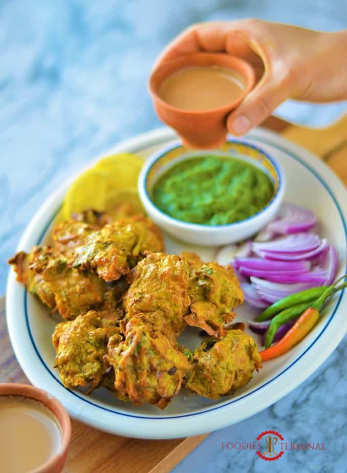 Chicken pakora served with accompaniments & indian tea in clay cups