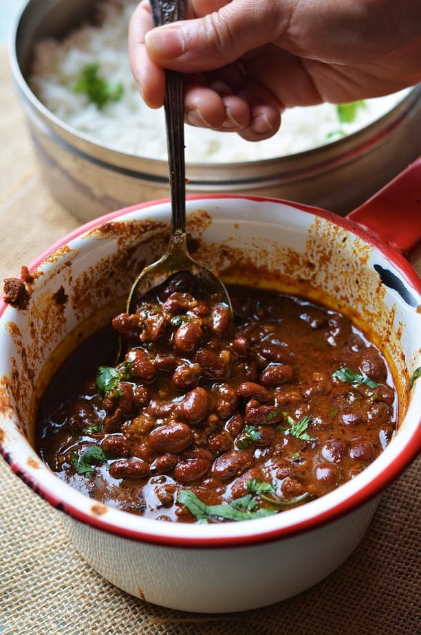 Instant Pot Rajma Masala is served in a white sauce pan with red rim