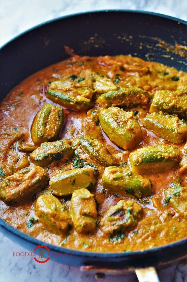 Potol Korma recipe cooked in a black skillet