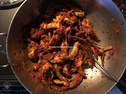 Sauteing the crab pieces with the bhuna masala