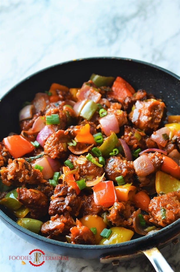 Chilli Chicken tossed in sauces in skillet