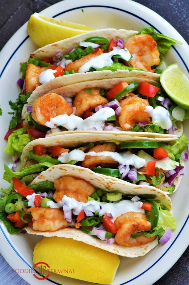 Cajun Shrimp Tacos garnished with sour cream sauce