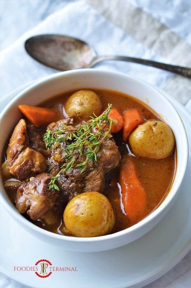 Lamb stew in Instant Pot garnished with fresh thyme