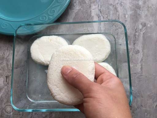 Taking out the cooled Cream chops from the sugar syrup