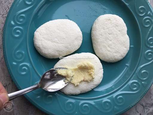 Applying malai on the top of the cream chops