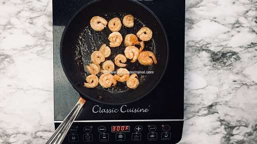 Frying shrimps on a skillet