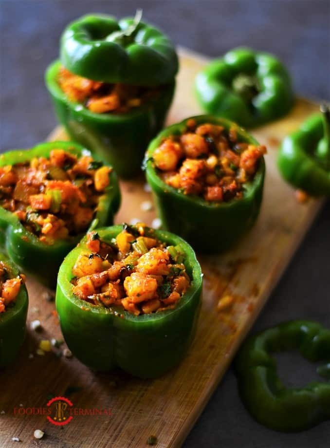 Stuffed bell peppers with shrimp on a wood board