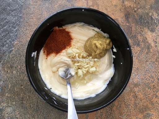 Ingredients for Aioli in a black bowl