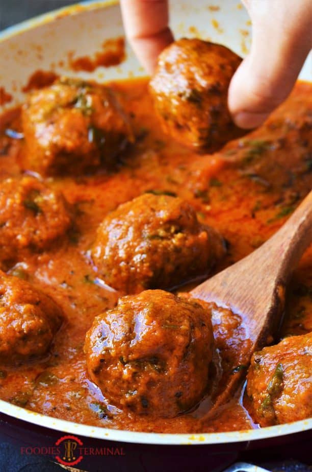 Mutton Kofta Curry with a wooden spoon