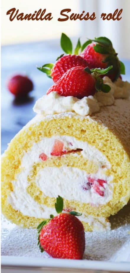 Cake roll decorated with whole strawberries