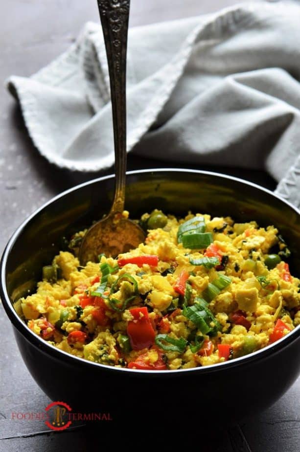 Tofu Scramble with nutritional yeast in a black bowl