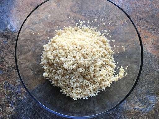 Cooked & drained quinoa in a transparent bowl