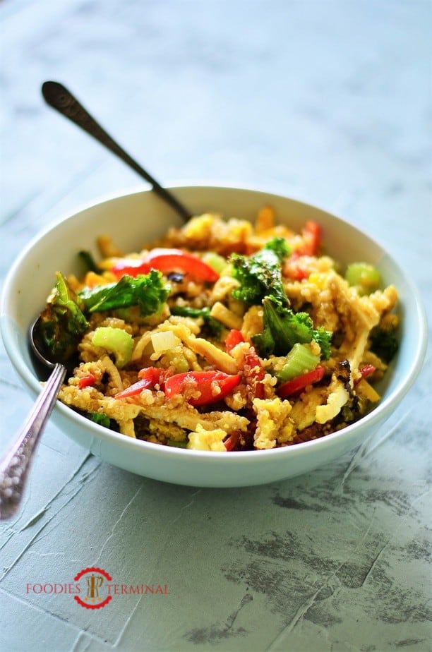 Warm quinoa salad served in a blue bowl