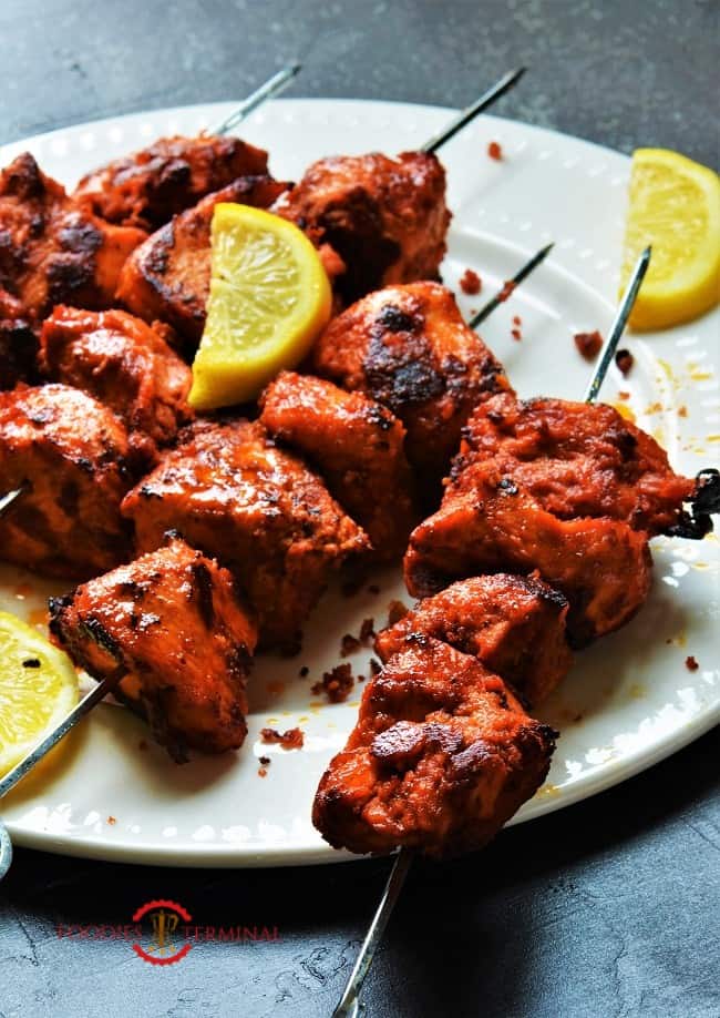 Chicken boti kaba skewered & kept on a white plate