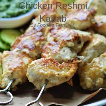 chicken reshmi kabab skewered in metal skewers