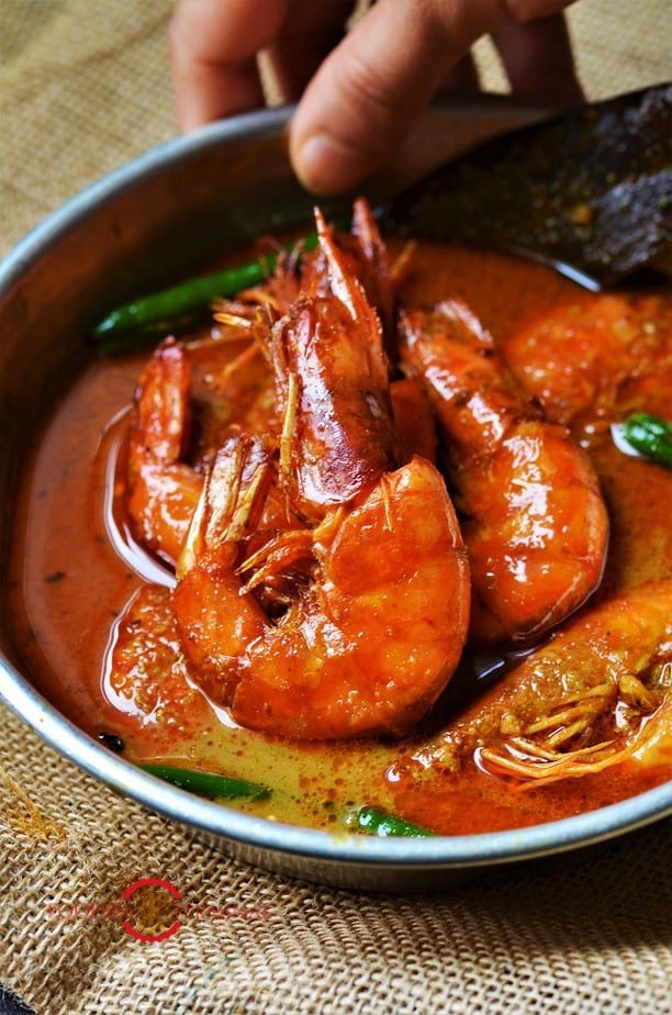 Prawn Malai Curry cooked with colossal prawns & served in a small metal plate kept on a jute placemat