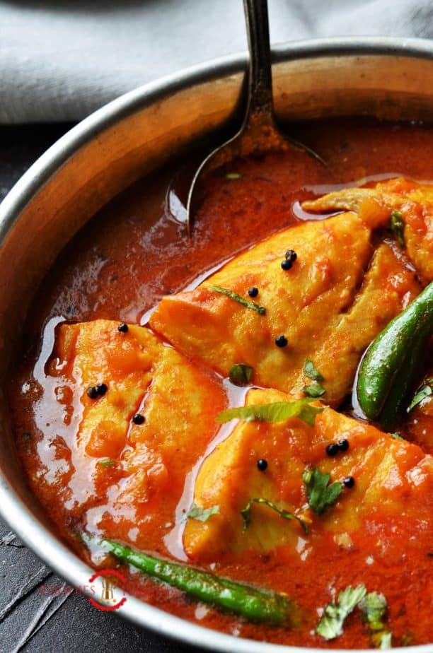 Instant pot Tilapia curry in a red sauce garnished with chopped cilantro & green chilies