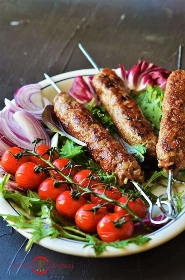 Mutton seekh kabab served on a white plate