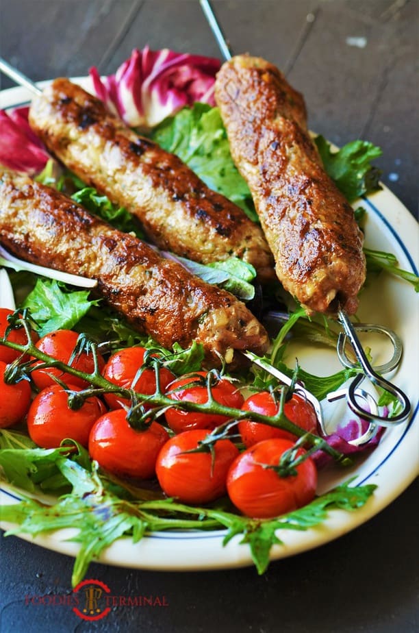 Mutton Seekh kabab served with cherry tomatoes