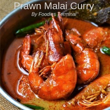 Prawn Malai Curry served in an aluminum plate in a red curry sauce