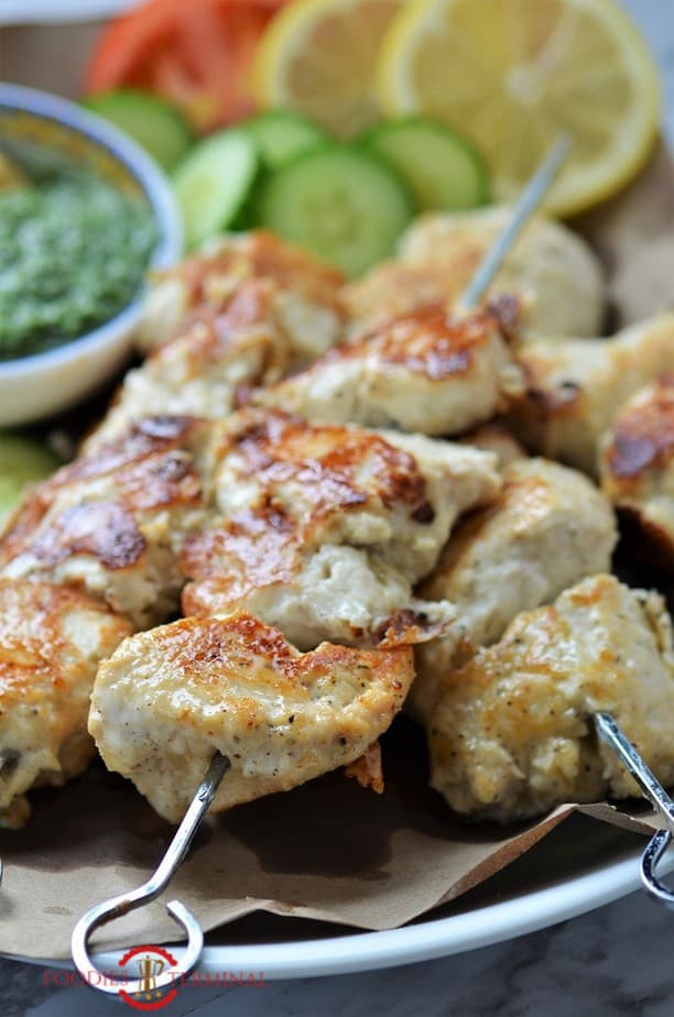 Chicken reshmi kabab skewered to metal skewers