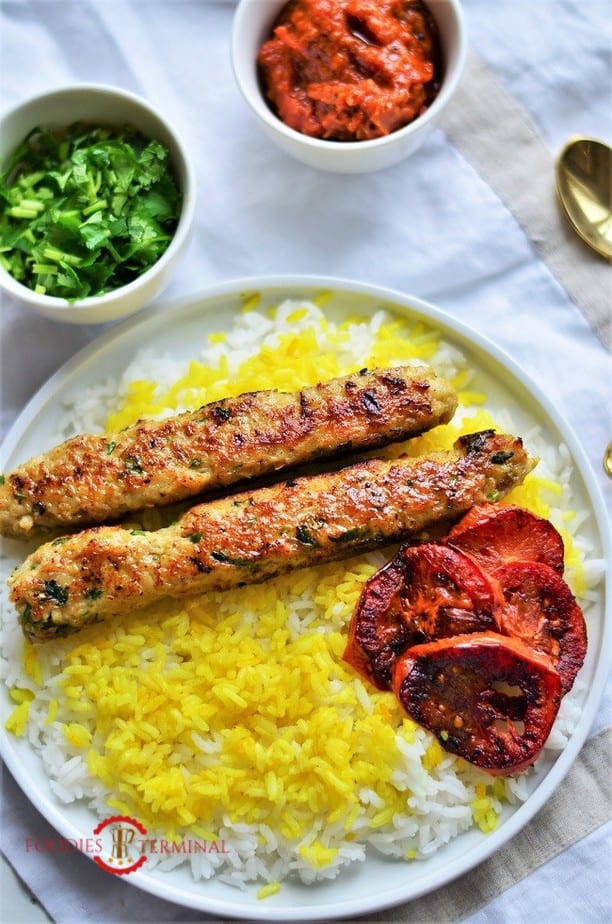 Chicken seekh kabab over saffron rice & roasted tomato wedges