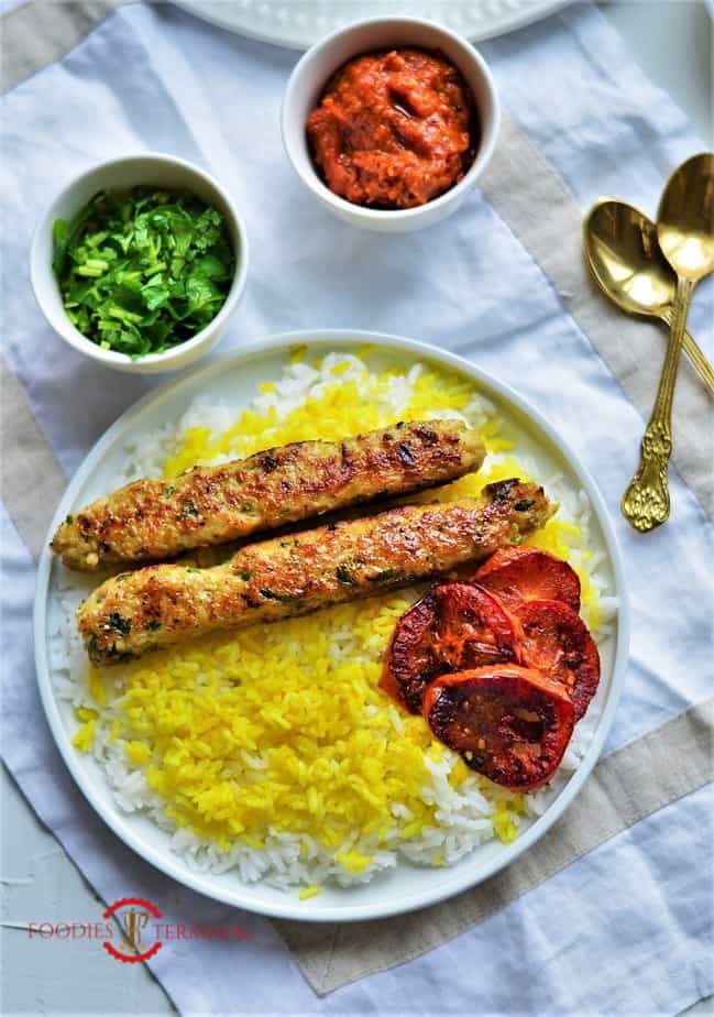 Chicken seekh kabab two pieces served on yellow rice