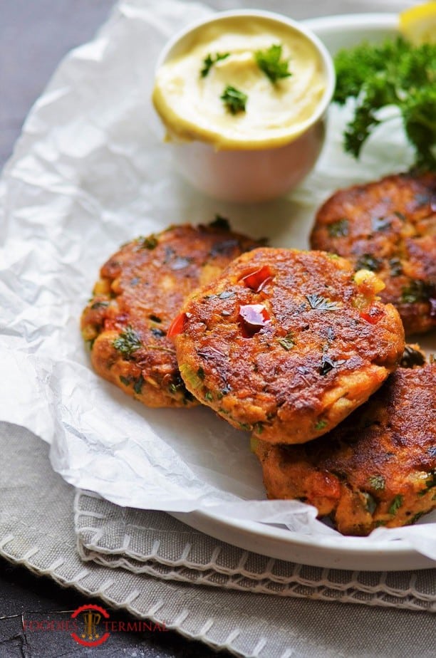 Salmon Patties with flour served on a parchment paper lined plate