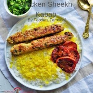 Chicken seekh kabab served over a bed of turmeric rice