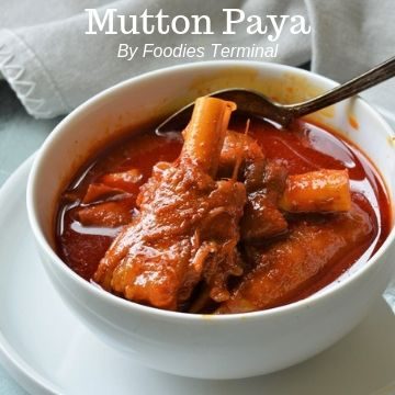 Mutton Paya in a white bowl with goat trotters