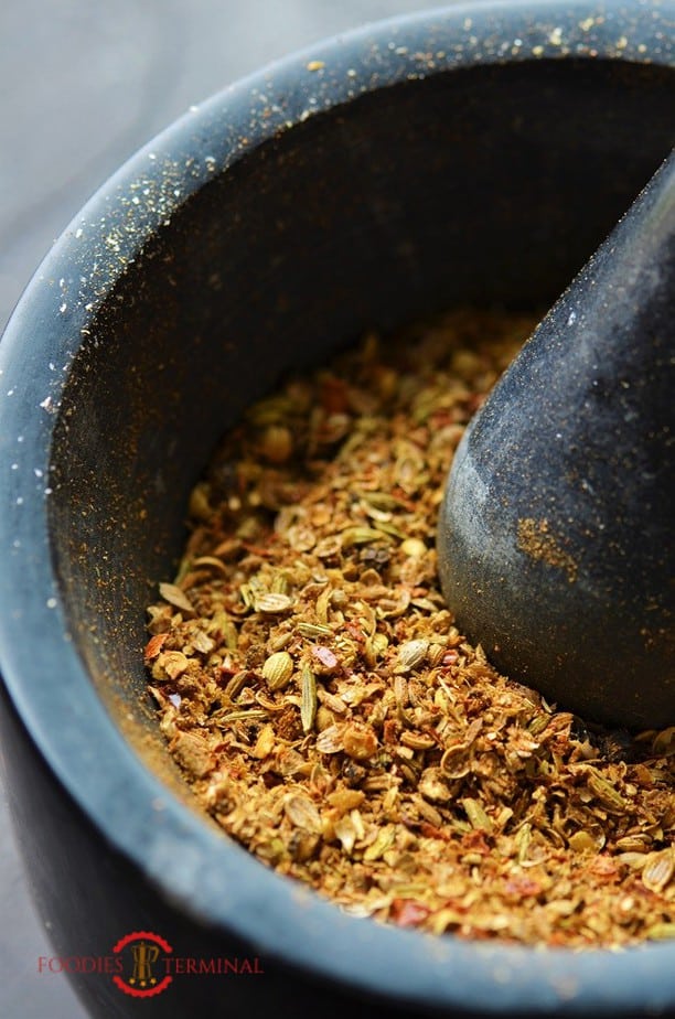 Karahai Masala powder in a black stone mortar pestle