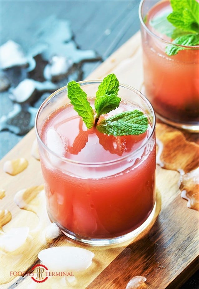 KoKum sherbet lovely pink drink in glass with ice & fresh mint leaves