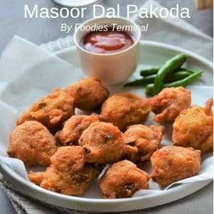 Masoor Dal Pakoda served on a white plate