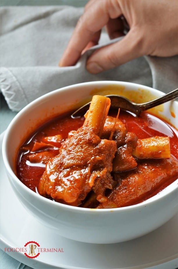 Instant Pot Mutton Paya in a red curry served in a white bowl 