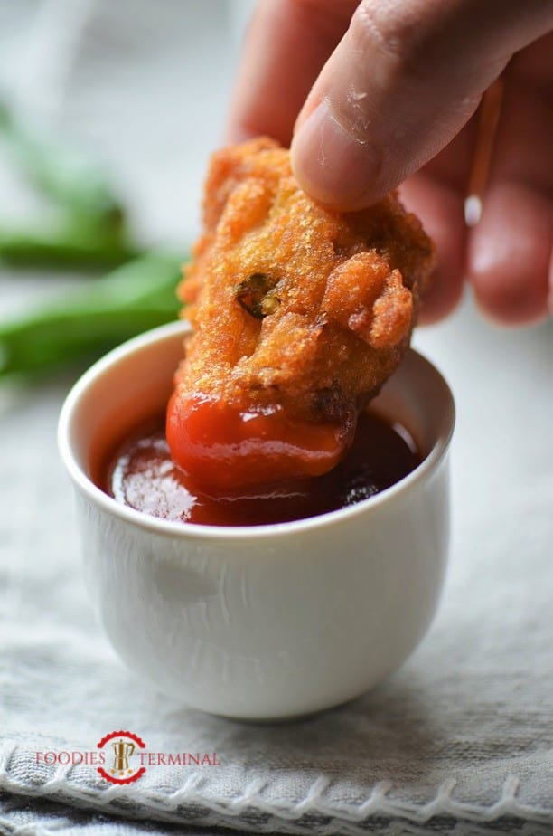 Masoor dal vada dipped in ketchup