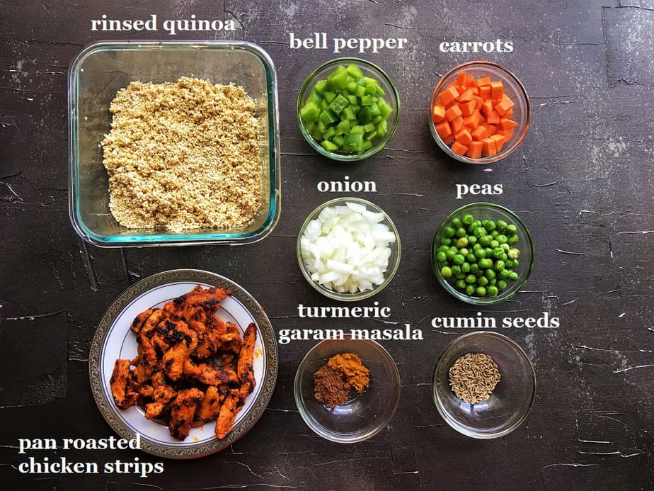 Recipe ingredients kept on individual bowls on a black board