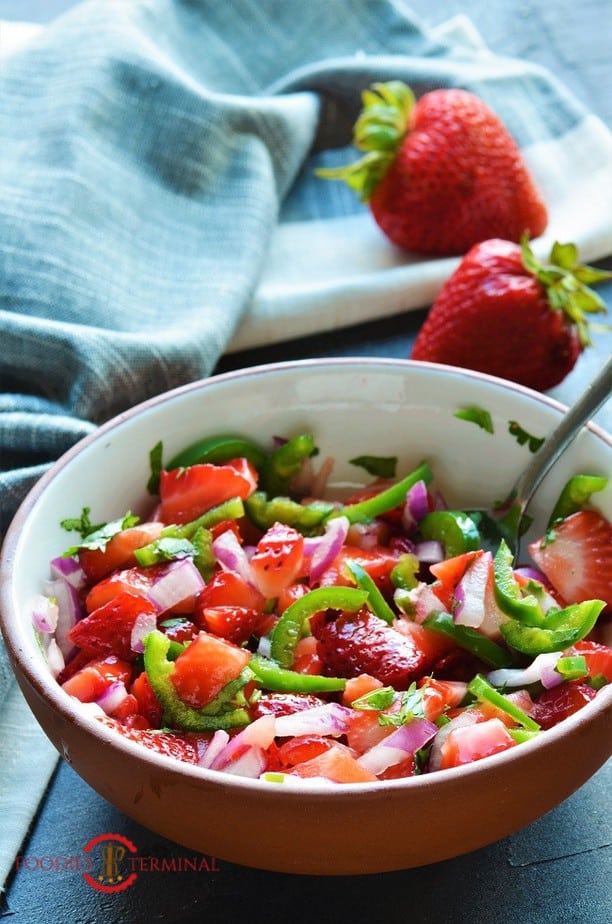 Strawberry Jalapeno Salsa in a bowl with a cloth napkin in the background