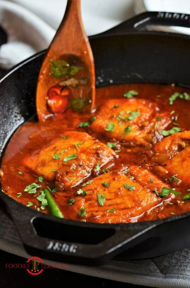 Easy Salmon curry in a red sauce served in an iron black wok