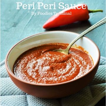 Red Piri Piri Sauce in a terracotta bowl with a spoon