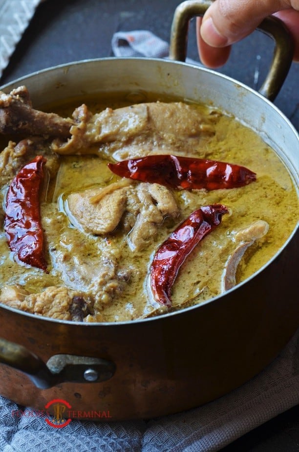 Chicken Rezala garnished with dry red chilies